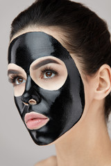 Beauty Face Black Mask. Woman With Black Cosmetic Mask On Skin
