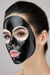 Beauty Face Black Mask. Woman With Black Cosmetic Mask On Skin
