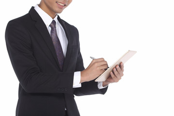 Asian Look Tan Skin Business Man in Black Suit Pant Shoe necktie, studio lighting white background isolated, checking tablet and ditigal sign on express feeling happy successful yes wow