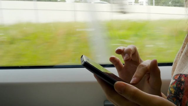 Woman Passenger Travel On Train And Text Messaging On Mobile Phone