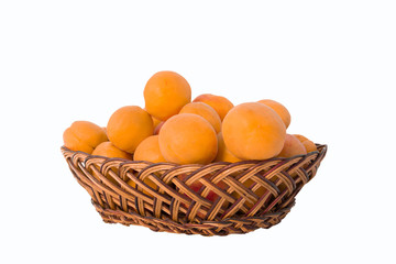 Apricots in a basket of rattan on a white background