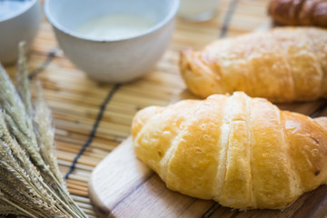 fresh bread and baked goods on wooden chopping board, rustic style