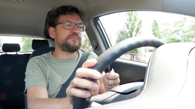 Funny man cleaning dirty hands while driving car