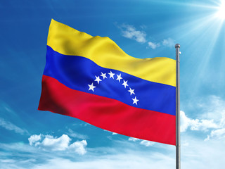 Venezuela flag waving in the blue sky