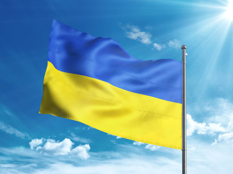 Ukraine flag waving in the blue sky