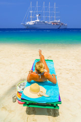 Woman sitting on a bed at the beach
