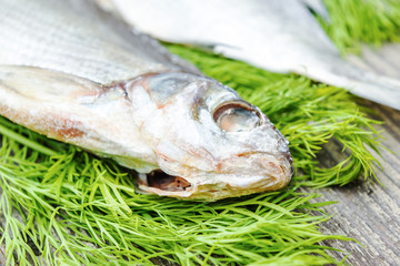 Dried salted fish on the old wooden table