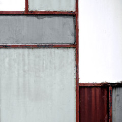 Geometric iron texture steel door background. Red and grey metal sheet gate. Composition and elements of visual design. Vintage and hipster. De stijl. Close up.