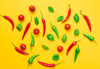 Above view at Chili pepper and tomatoes with basil