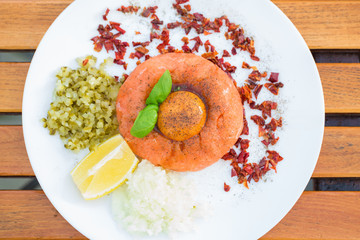 Salmon tartar with cucumber egg and onion