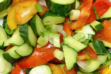 Fresh salad of cucumbers, tomatoes, greens and vegetable oil
