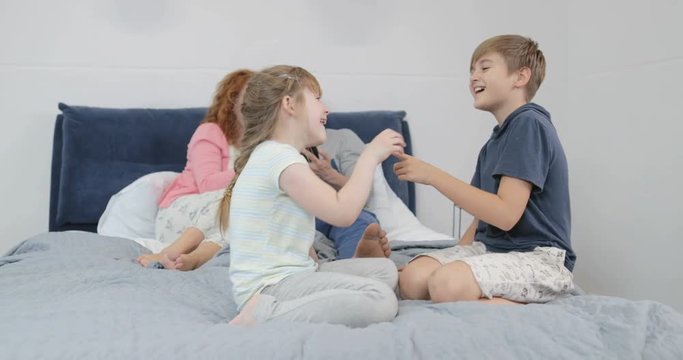 Happy Family Together On Bed In Bedroom Parents Spending Time With Children At Home Slow Motion 60