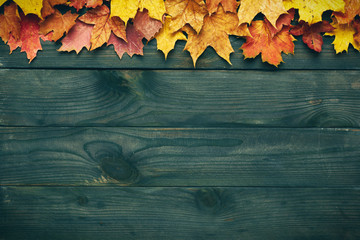 Wooden background with autumn leaves