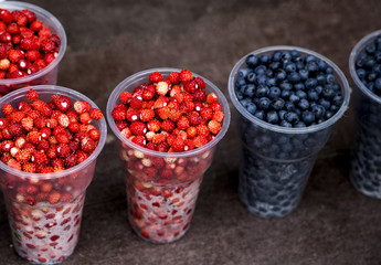 wild strawberry and blueberry from the forest on the wood table