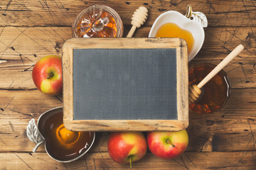 Rosh hashanah jewish new year holiday celebration concept. Honey and apples over wooden background....