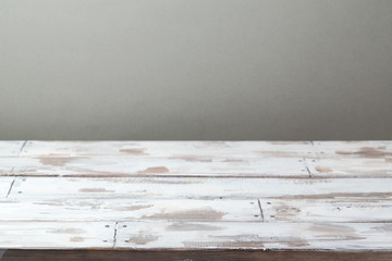 Empty wooden rustic table over wall background