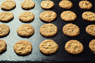 Biscuit sweet cookie background. Domestic stacked butter biscuit pattern concept,close up macro.Homemade cookies on wooden table.Cereal biscuits with the sesame,peanuts,sunflower and amaranth.