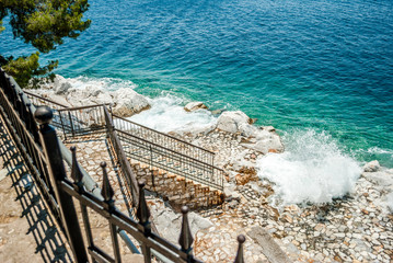 Blue sea and sharp rocks that surround it