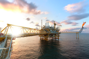 Offshore oil  platform in sunset or sunrise time. Construction of production process in the sea. Power energy of the world.