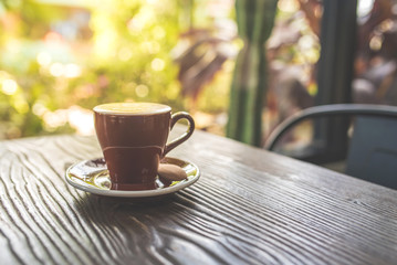 Top view of cappuccino hot coffee on wooden table background in a coffee shop.