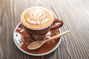 cappuccino hot coffee on wooden table background.