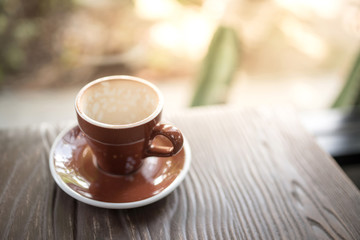 Empty coffee cup after drinking on wooden table in the morning.