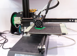 Modern 3D printer printing figure close-up macro