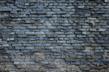 Ruined wall of brick gray.