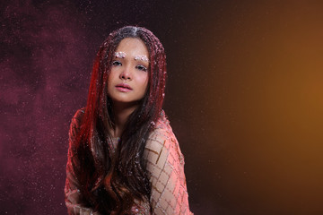 Woman with Gllitter Snowflake in dark background