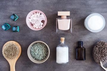 SPA cosmetics, woman body and skincare products on gray. Top view