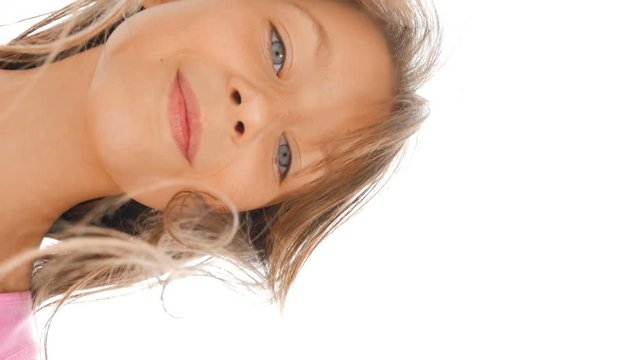 Blue-eyed girl.&nbsp;Beautiful girl with blue eyes looks at the camera. Happy child. Close-up.