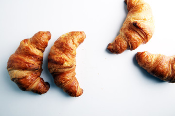 freshly baked croissants on white board, bakery concept