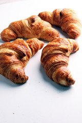 freshly baked croissants on white board, bakery concept