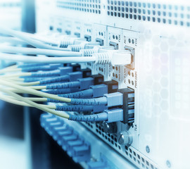 Fiber Optic cables connected to an optic ports and Network cables connected to ethernet ports