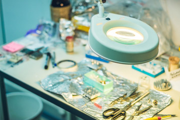 Sample preparation table with a lamp-magnifying glass in a laboratory