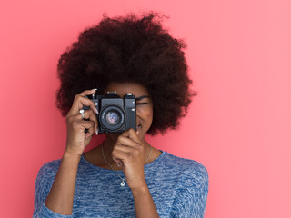 young black girl taking photo on a retro camera