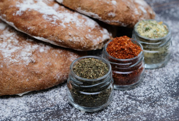 Fresh  bread and different spicies in jars