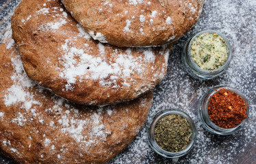 Fresh  bread and different spicies in jars