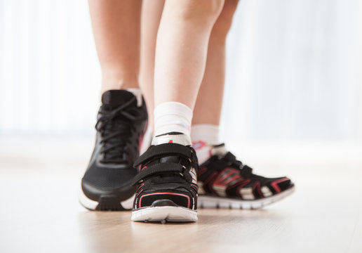 Women's and child's feet in sneakers
