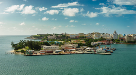 Fototapeta na wymiar Scenic view of historic colorful Puerto Rico city in distance with fort in foreground