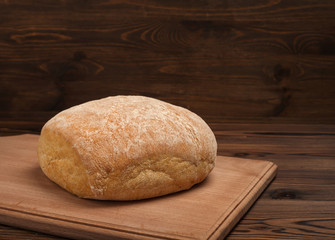 ciabatta bread over dark wooden table background, rustic style, close up