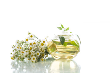 Glass teapot with chamomile tea