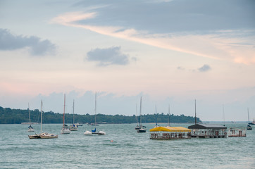 Changi, Singapore - April 30, 2017: Small private yacht anchored along the Changi Boardwalk span a 2.2 km and includes a jogging track, fitness corners, rest areas and car park for visitors.
