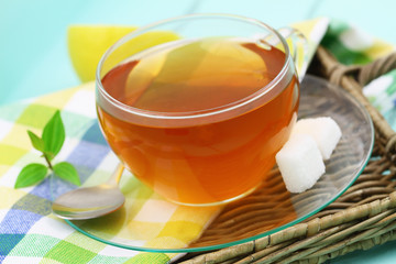 Cup of lemon tea with two cubes of sugar, closeup
