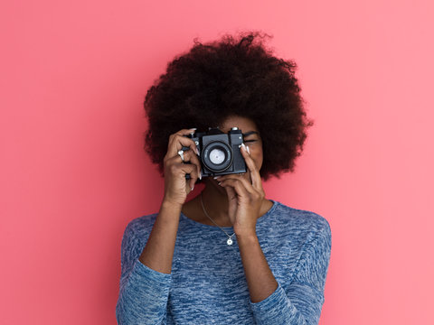 young black girl taking photo on a retro camera