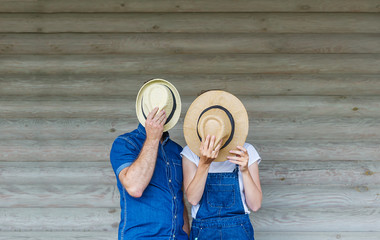 Young couple with hats. Hides their faces.
