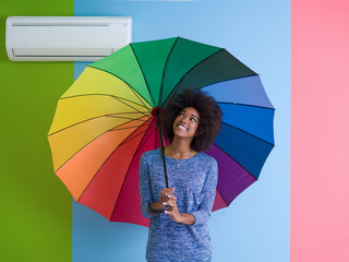 young black woman holding a colorful umbrella