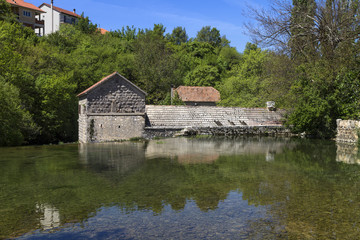 Fototapeta na wymiar An old grain mill on the Grab River near the town of Sinj in Croatia