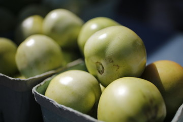 Green tomatoes for sale at the farmers market 