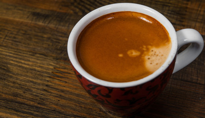 Cup of hot espresso coffee on wood table. top view. with copy space.